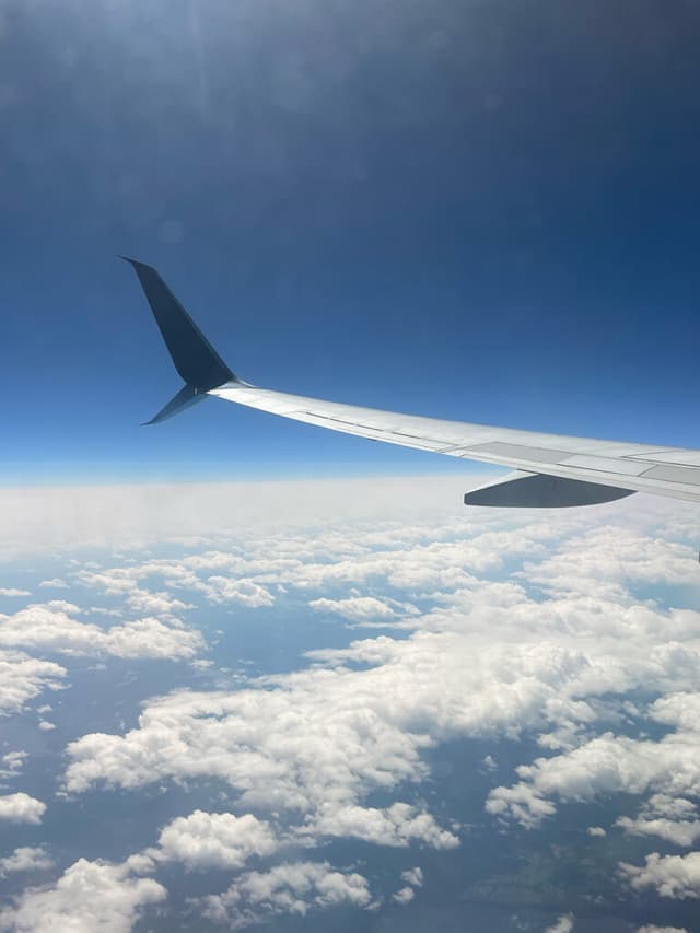 picture of a window seat plane with clouds